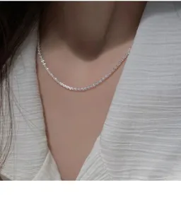 Detail view of a sparkling 925 silver star necklace, elegant collarbone chain jewelry piece.