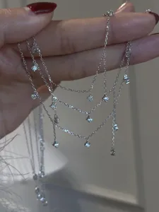 Detailed close-up of multi-layered silver zircon tassel chain showcasing delicate sparkling drops.