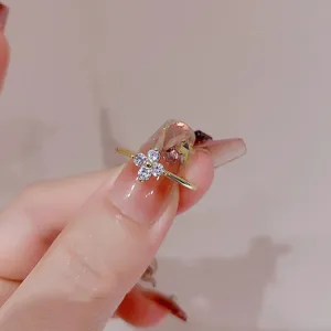 Close-up detail of a delicate sterling silver four leaf clover ring with sparkling zirconia.
