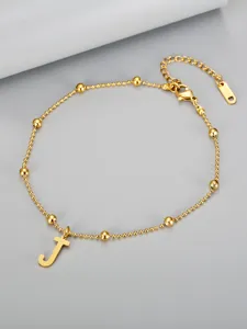 Macro view of 18k gold plated titanium steel beaded anklet with letter J pendant