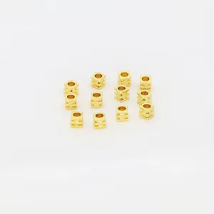 Close-up of electroplated gold square spacer beads, ideal for DIY jewelry making and bracelets.