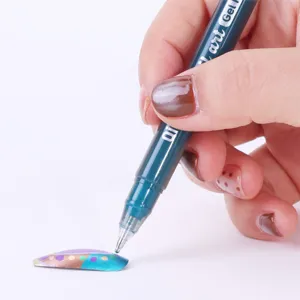 Macro view of a dark teal metallic nail art pen tip drawing precise designs on a nail.