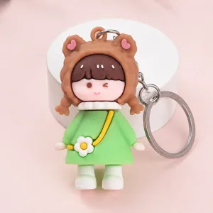 Cute cartoon bear girl keychain detail view, soft rubber doll pendant for bags or keys.