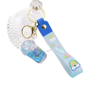 Porte-clés mignon en silicone gelée avec pendentif tasse de thé au lait pailleté.