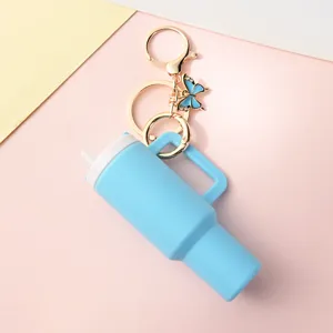 Mini tumbler keychain with handle and straw, portable lipstick storage pendant for bags and keys.