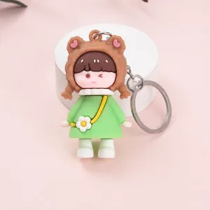 Cute cartoon girl keychain pendant with green dress, soft silicone bag charm for keys and bags.