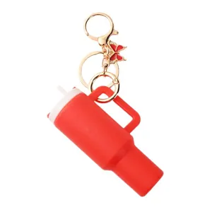 Mini red tumbler keychain with cute butterfly charm, portable metal ring pendant for bag decor.