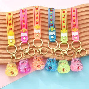 Creative liquid quicksand lucky cat keychain, cute acrylic oil-filled car pendant bag charm.