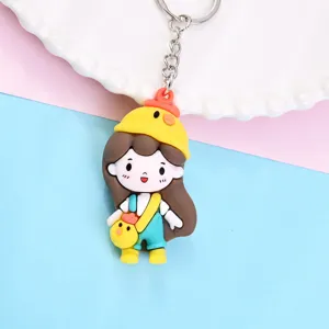 Cute cartoon girl keychain with duck hat pendant, PVC bag charm accessory for keys and bags.