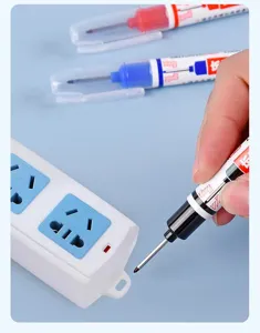 Detail of a black long nose deep hole marker pen being used on a power strip