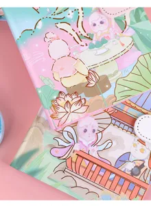 Close-up detail showing the gold bronzing on cute cartoon bunny notebook covers