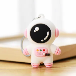 Cute astronaut keychain, cartoon spaceman pendant, white and pink silicone bag charm accessory.