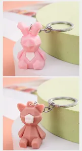 Geometric polygon cartoon animal keychain detail view, soft PVC material pendant.