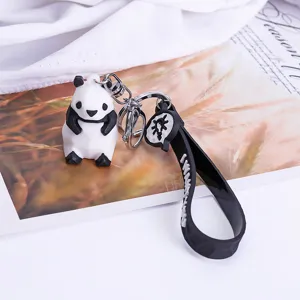 Cute geometric panda keychain with black silicone strap and metal ring, perfect bag charm.