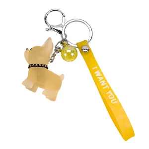 Cute cartoon dog keychain with yellow strap and metal ring, perfect fashion bag charm.
