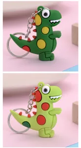 Cute green dinosaur keychain detail view, pop it bubble design, metal keyring for bags.