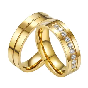 Detailed view of gold-plated stainless steel couple rings with cubic zirconia inlay