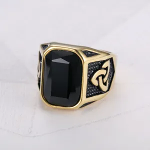 Close-up of men's Viking ring with large black rectangular stone and Celtic knot