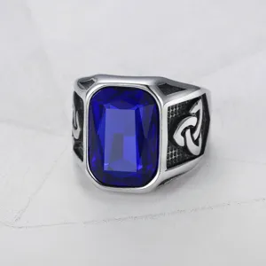 Detailed close-up of men's Viking ring with large blue gemstone and Celtic knot engraving