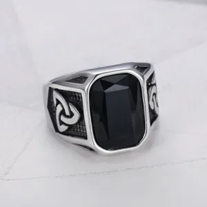 Detailed macro view of vintage titanium steel ring with black gemstone and Celtic knot