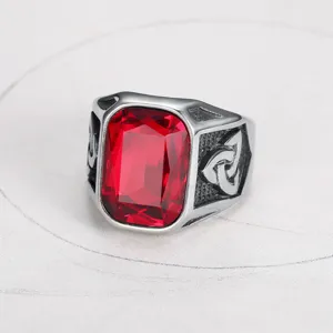 Close-up of vintage stainless steel men's ring with large square red gemstone