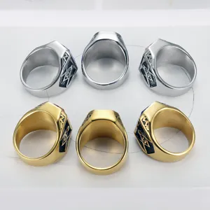 Detailed macro view of gold and silver Freemasonry signet rings featuring AG ruby accents