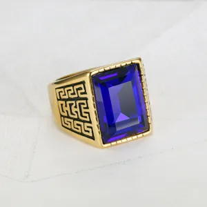 Detailed macro view of vintage hip hop ring with blue gemstone and Greek key engraving