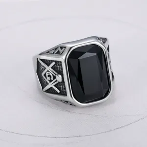 Close-up detail of a titanium steel Freemason signet ring featuring a large black gemstone