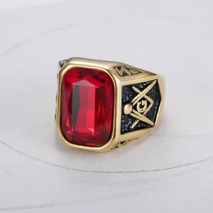 Detailed close-up of a gold Masonic ring with a large rectangular red ruby stone.