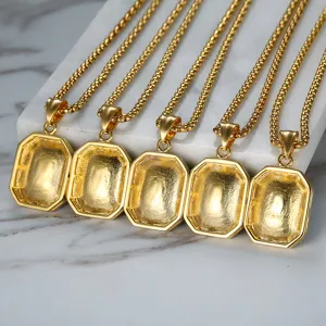 Close-up of five elegant gold-plated octagonal pendant necklaces on marble surface.
