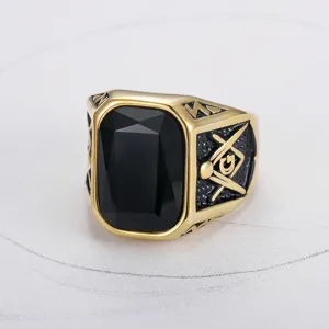 Detail view of gold-toned Masonic signet ring featuring a large rectangular black onyx stone