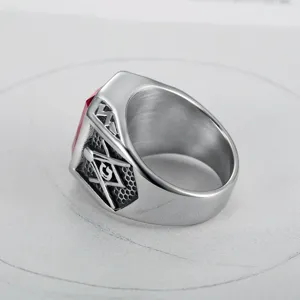 Detailed side view of a Freemasonry stainless steel ring featuring a vibrant red gemstone
