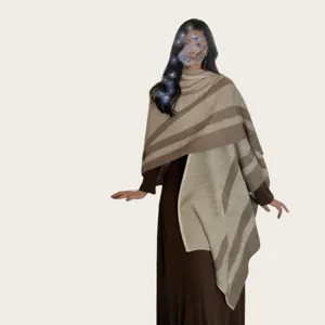 Details of the stylish striped knitted shawl and poncho showing cozy texture and warm design.