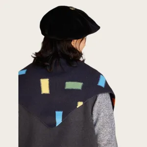 Close-up detail of the stylish knitted triangular shawl with colorful color-block patterns.