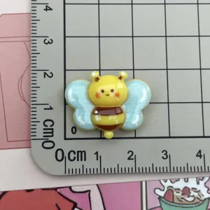 Cute yellow bee resin cabochon detail shot, perfect for DIY phone case and craft decoration.