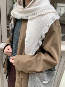 Cozy knit triangle scarf detail, cream color shawl with fringe, warm autumn winter neck wrap.