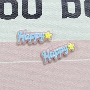 Close-up detail of cute jelly-color resin Happy letter charms with yellow stars for DIY crafts.