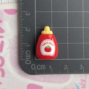 Mini resin tomato sauce bottle charm for handmade crafts, DIY jewelry and phone case decor.