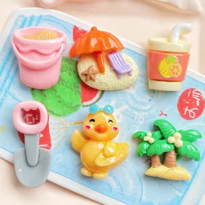 Detailed view of summer beach resin cabochons, cute duck and palm tree DIY charms.