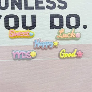 Close-up of colorful resin jelly letter charms, cute DIY accessories for phone cases.