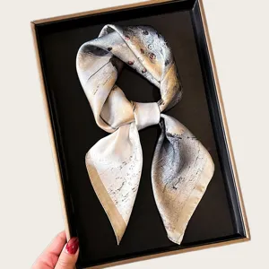 Close-up detail of the elegant women square silk scarf, soft thin fabric for neck or hair wear.