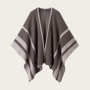 Striped knit poncho cape detail view, soft cozy fabric texture, elegant open front outerwear.