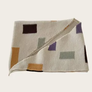 Detailed view of women knitted color block shawl scarf, cozy geometric pattern, autumn winter.