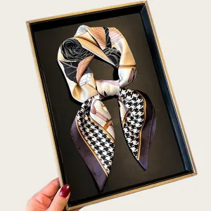 Chic silk square scarf with houndstooth and floral print, perfect for neck or hair accessory.