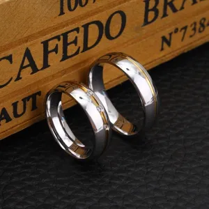 Pair of minimalist stainless steel couple rings with gold-plated bands and inlaid stones