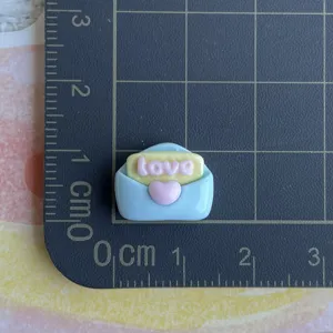 Mini envelope resin charm detail showing size scale for DIY phone case hair clip craft accessory