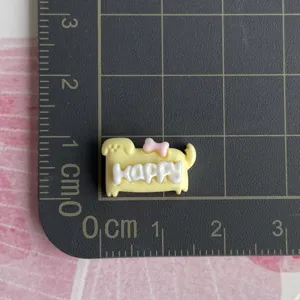 Mini resin dog charm detail with happy text, perfect for DIY hair clips and craft accessories.