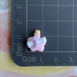 Mini resin wishing bottle charm detail shot, perfect for DIY phone case and hair clip crafting.