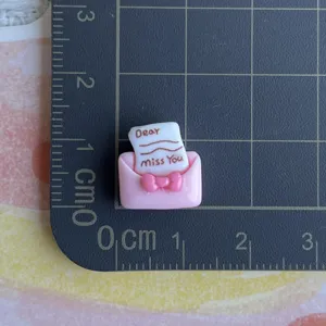 Mini pink envelope resin charm with bow and letter for phone case DIY craft decoration.
