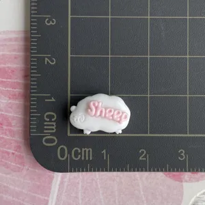 Mini resin sheep charm with pink letters detail shot for DIY hair clips phone cases.